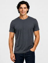 Load image into Gallery viewer, A man wearing a dark gray crew-neck t-shirt and dark blue jeans, standing against a light gray studio background.